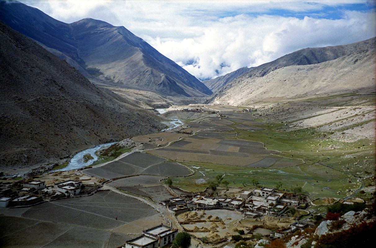 01 View Back Towards Nyalam From Milarepa Cave Just 10 km from Nyalam is a cave where the famous Tibetan Yogi, Milarepa, meditated for many years in the 11C. This is the view back towards Nyalam in 1998, with the Zhonggang village below.